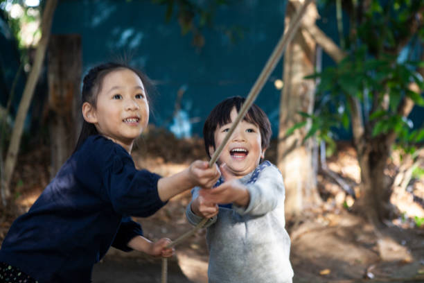 istock Children playing with playthings in the park. A close Siblings. 1074147474
