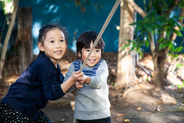 istock Children playing with playthings in the park. A close Siblings. 1074147482