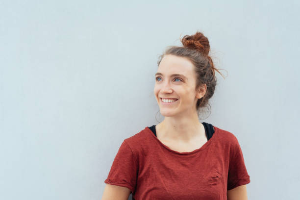 istock Young woman looking up with a happy smile 1074148082