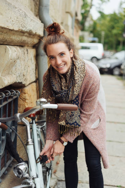 istock Smiling happy young woman with her bicycle 1074149744