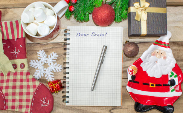 istock Christmas wish list on wooden background with decorations 1074149992