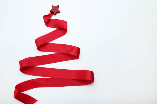 istock Red ribbon in shape of christmas tree on white background 1074151062