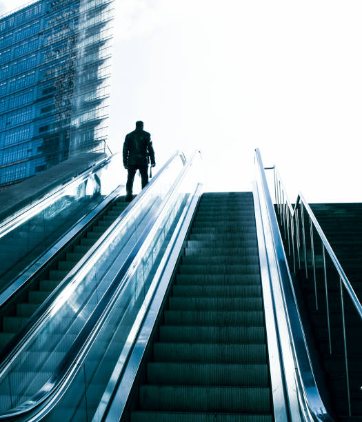 istock Business man on the escalator 1074151152