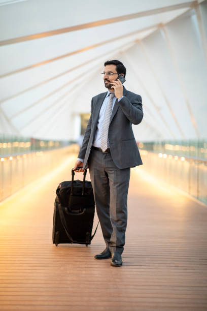 istock arab businessman with his suitcase on a phone  in Dubai 1074152604