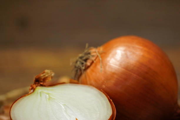 istock Onion and onion sliced on a rustic wood table 1074152684