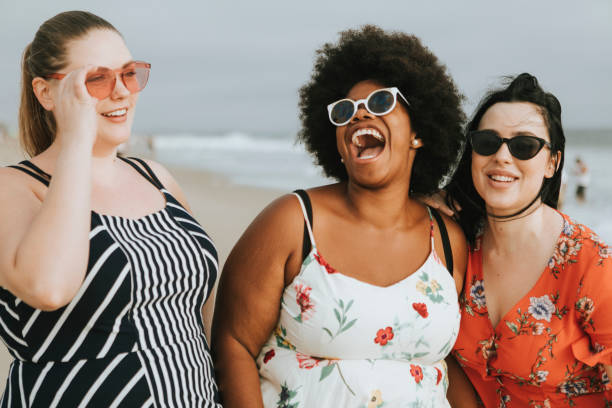 Cheerful diverse plus size women at the beach Cheerful diverse plus size women at the beach body confidence stock pictures, royalty-free photos & images