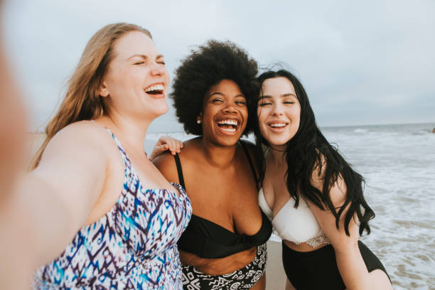 istock Beautiful curvy women taking a selfie at the beach 1074154622