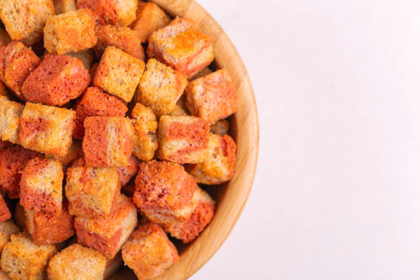 istock Bacon flavored crackers in wooden bowl on light marble background 1074155278