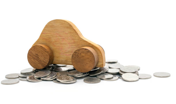 istock car and coins on white background 1074156310