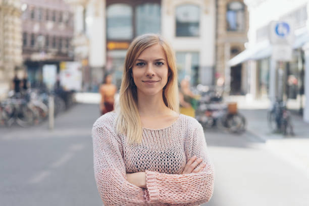 istock Self-assured young woman with folded arms 1074158074