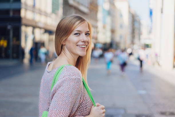 istock Young woman looking over her shoulder 1074158164