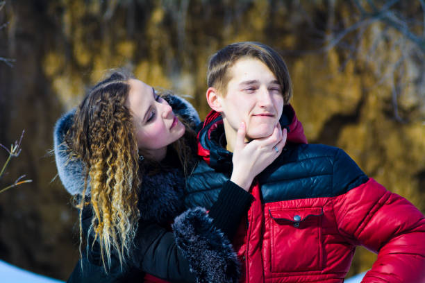 istock loving young couple in winter in park 1074160110