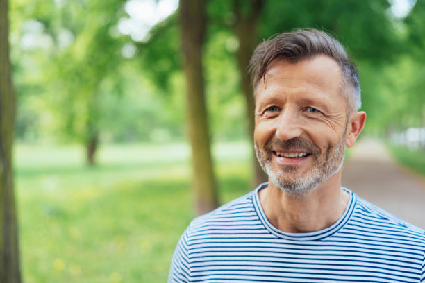 istock Happy mature man standing in park 1074160984