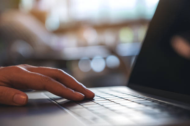 istock Closeup image of hand using and typing on laptop keyboard in cafe 1074164260