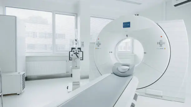 Photo of Medical CT or MRI or PET Scan Standing in the Modern Hospital Laboratory. Technologically Advanced and Functional Mediсal Equipment in a Clean White Room.