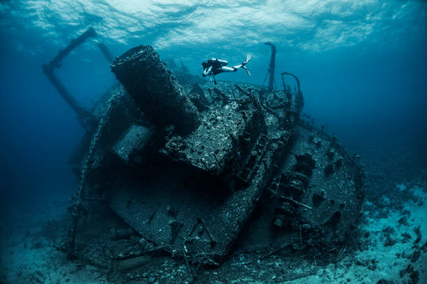 istock Scuba diver diving next to a large shipwreck under the Red Sea 1074166680