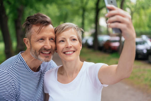 istock Joyful middle-aged couple taking a selfie 1074167274