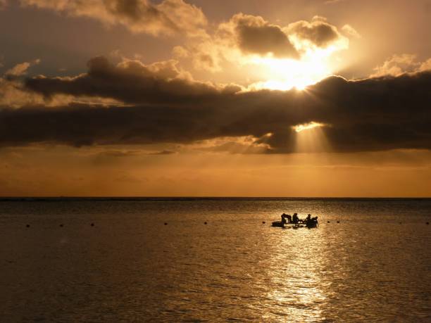 istock Sunset silhouttes on the water 1074169956