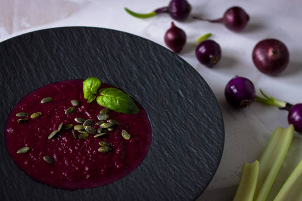 istock beetroot cream soup in black dish with celery and red onion. 1074171300