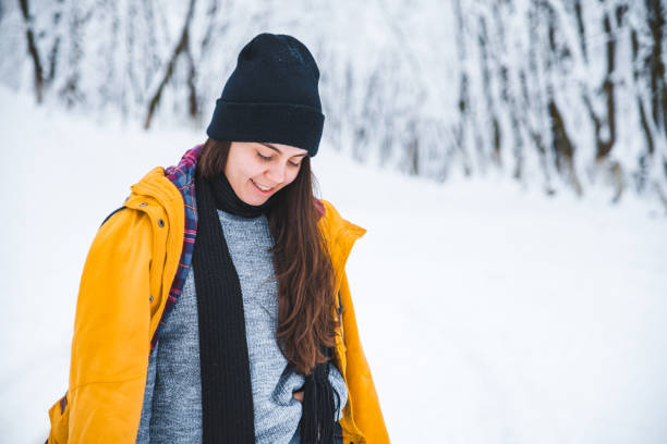 istock smiling woman portrait outdoors snow on hat 1074171752