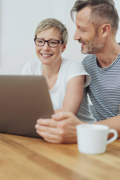 istock Woman beaming happily as she browses the internet 1074172140
