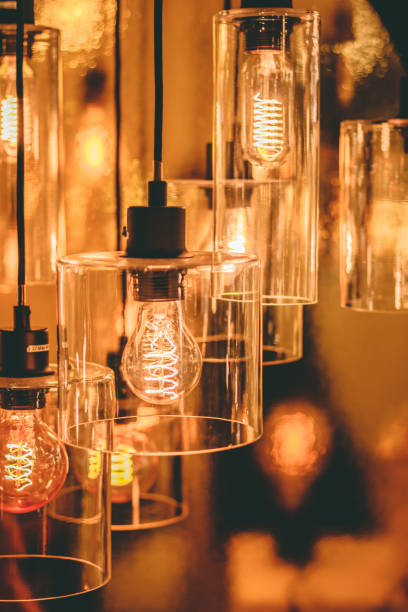 istock Close up view on a transparent modern lamp with a retro bulb inside it. 1074173916