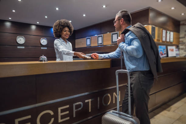 istock Businessman checking out at the hotel reception desk 1074175890
