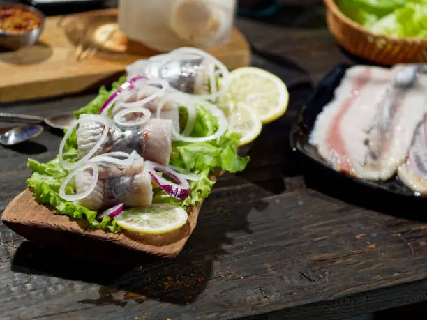 Serving rollmops, traditional European herring snack