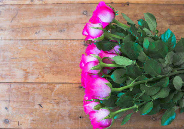 istock Pink Roses on a Wooden surface. 1074176566