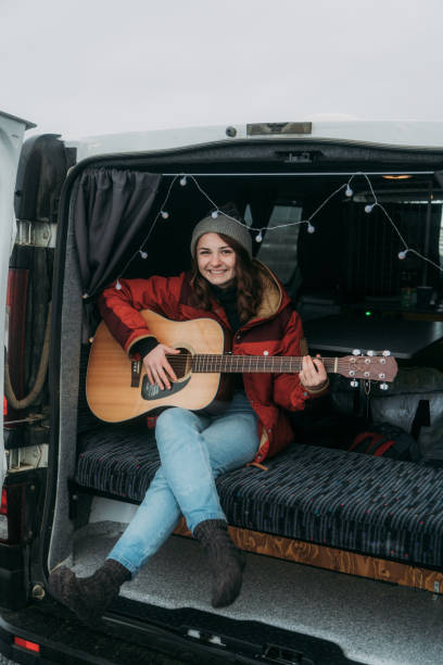istock Woman playing guitar  in camper van 1074177078