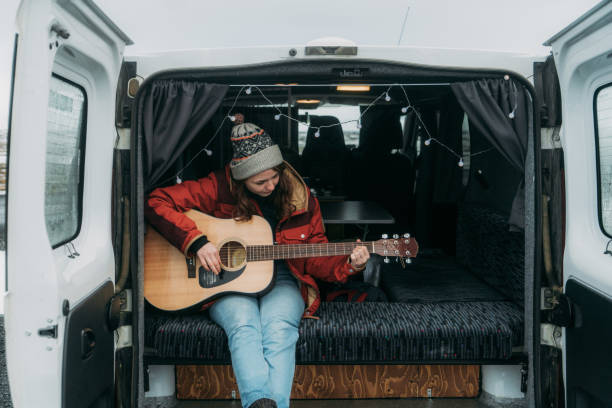 istock Woman playing guitar  in camper van 1074177082