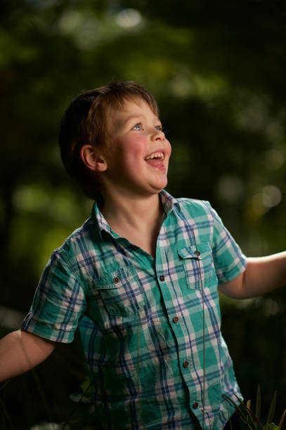 istock Formal Happy Portrait of a boy outdoors sideways glance 1074179540