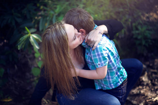 istock Mother comforting son hugging him 1074182016