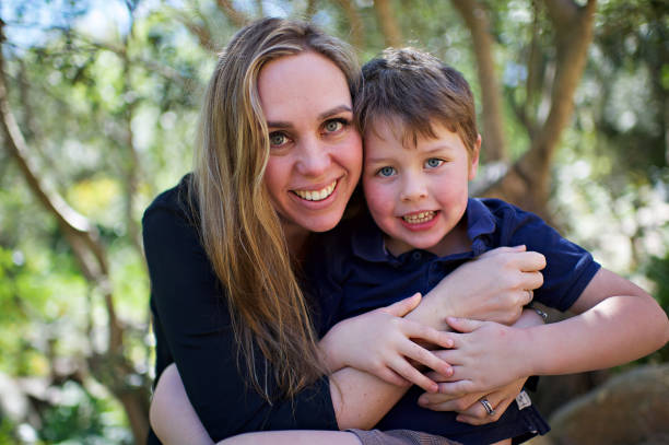 istock Mother and son portrait looking at camera smiling proudly 1074182298