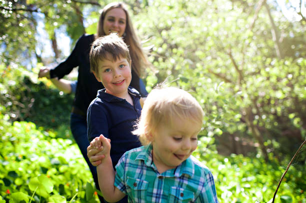 istock Family with two boys in a forest selective focus 1074182338