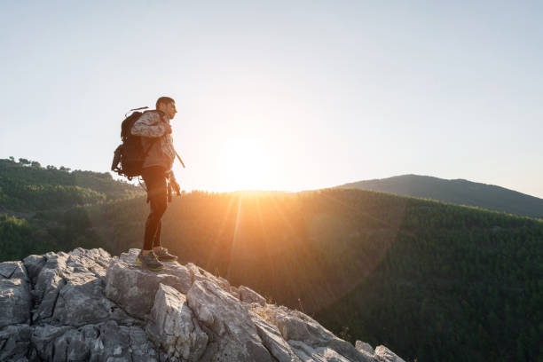 istock Hiker on top of mountains enjoy sunrise 1074184432