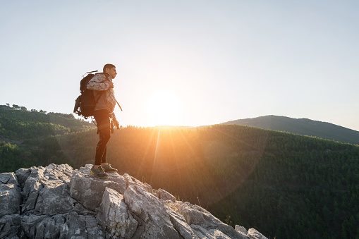 Hiker on top of mountains enjoy sunrise