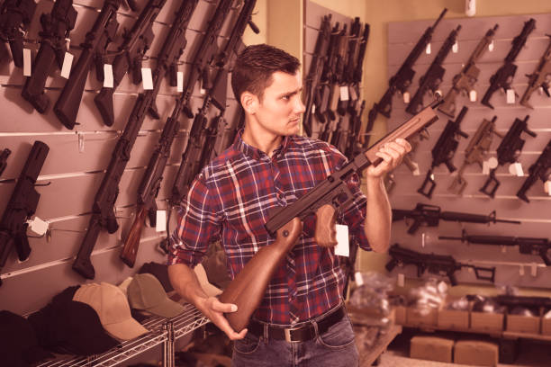 istock Male is choosing air-powered gun 1074187688