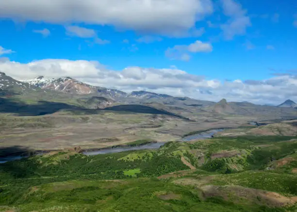 Photo of Breathtaking view valley of Thorsmork, with volcanoes, glaciers, green forest and blue sunny sky in summer day from the top of Valahnukur, southern Iceland, Europe