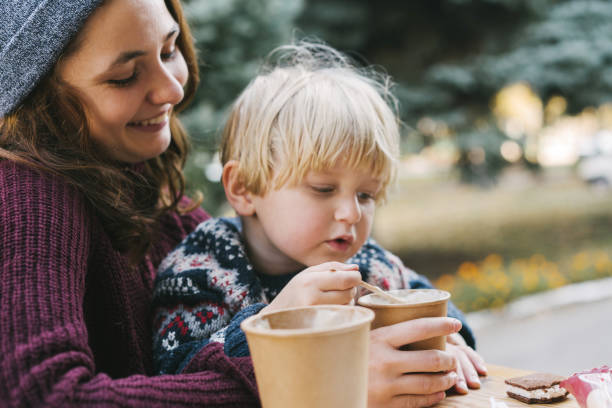 istock Woman drinking coffee with little boy 1074190866