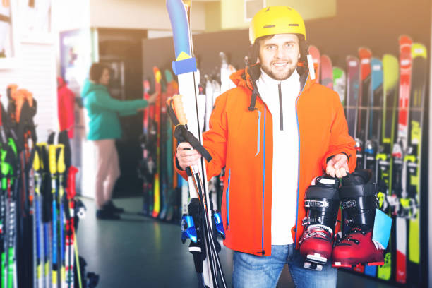 istock Cheerful young man posing in skiing gear during shopping 1074191030