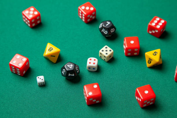 istock Collection of colored gaming dice cubes on green table 1074191096