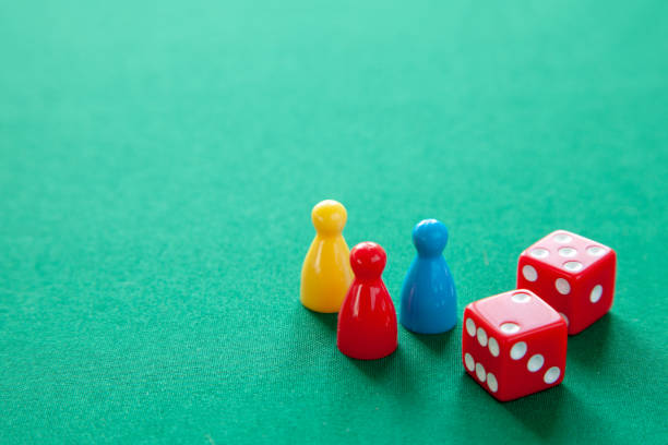 istock Colored game figures chips for board games. Collection of dice cubes on green table. Copy space for text 1074191146