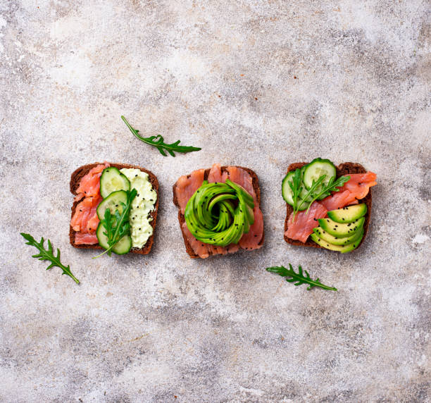 istock Healthy toasts with salmon and avocado rose 1074194472