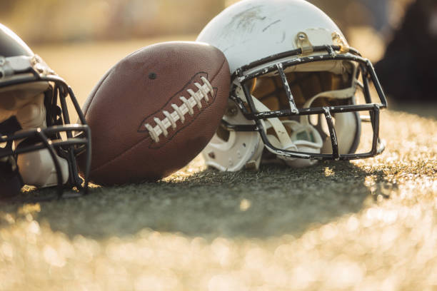 istock Football equipment on grass 1074194884