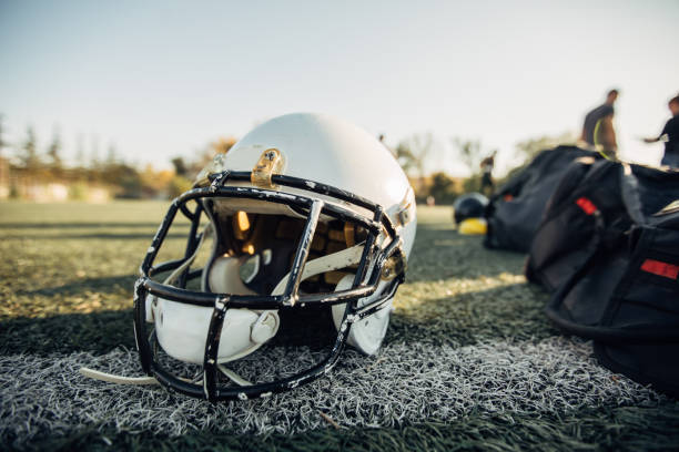 istock Football helmet on grass 1074197076