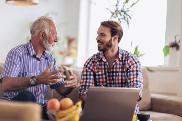 istock Adult Son Helping Senior Father With Computer At Home 1074197154