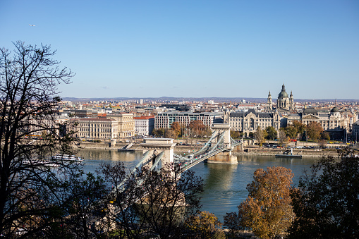 The Széchenyi Chain Bridge is a suspension bridge that spans the River Danube between Buda and Pest, the western and eastern sides of Budapest, the capital of Hungary. A view of the historic Chain Bridge from Gellert Hill in Budapest, Hungary.