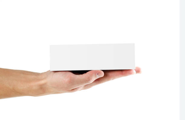 istock Hand holding white box. Close up. Isolated on white background. 1074211528