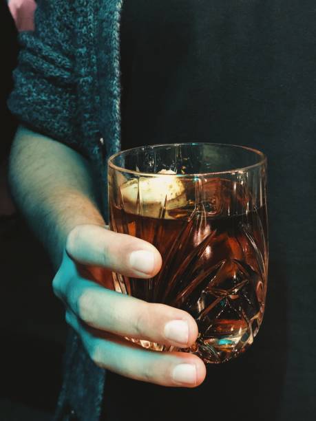 Man holding a glass of whiskey